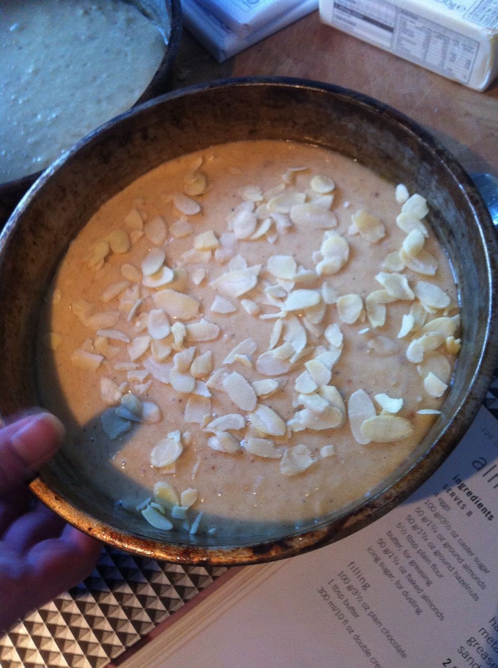Add almonds to ONE of the pans.
