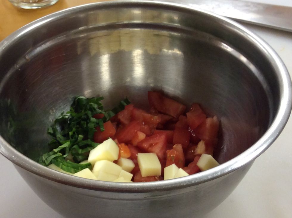 Add almost all of the basil in the bowl, but leave some out to garnish the platter.