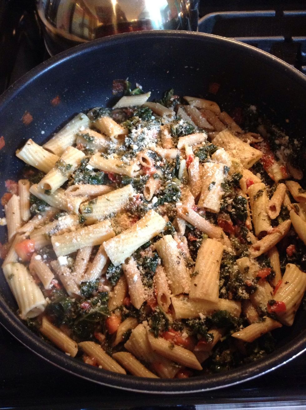 Add already cooked pasta, kale mixture, feta and stir together. Heat until hot. Adjust seasoning to taste. Sprinkle with Parmesan cheese.