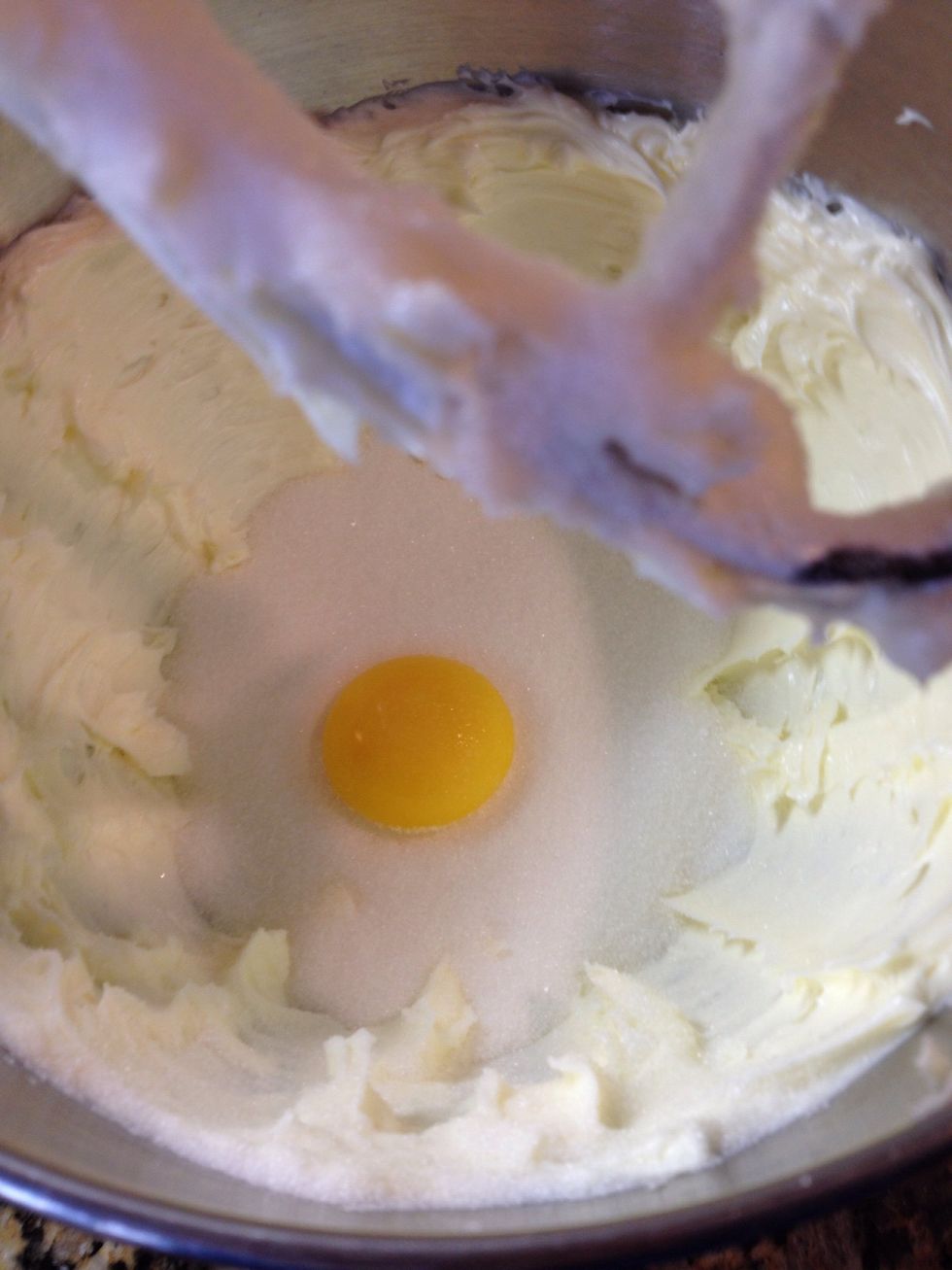 Add an egg yolk and 1 cup sugar. Cream that well for about 2 minutes