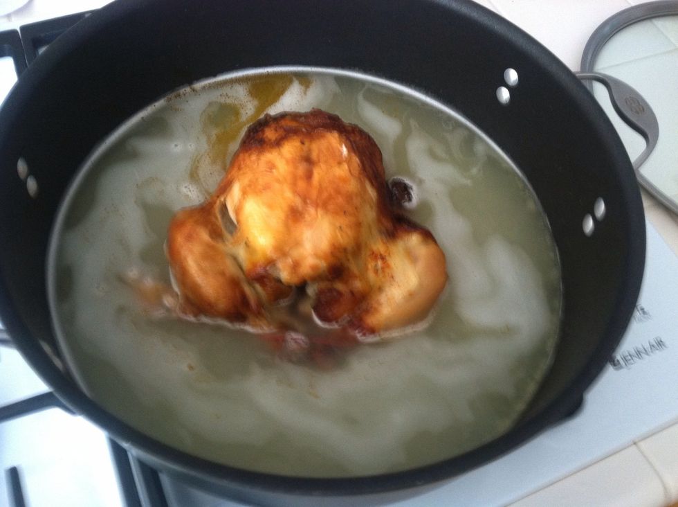 Add an entire precooked chicken to the bouillon mixture