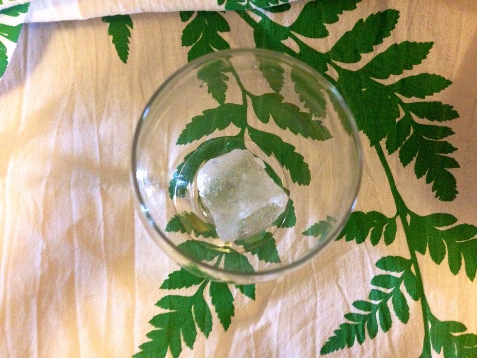 Add an ice cube to the glass.