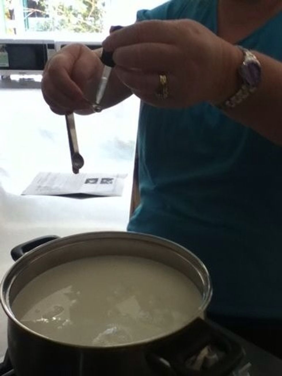 Add and stir in  the 1/8 teaspoon of Calcium chloride to the heated milk.