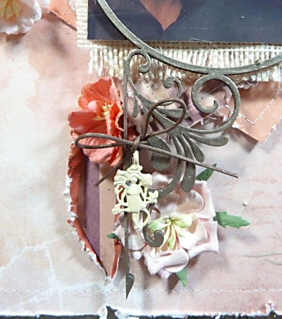 Add another cord bow with Vintage trinket hanging from it to the bottom cluster and slit.
