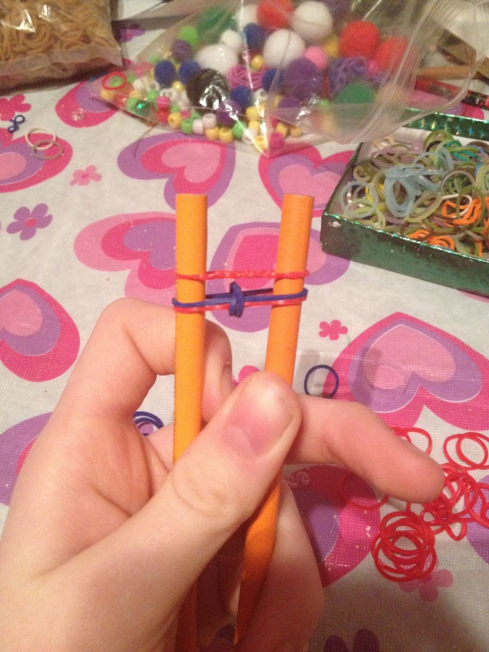 Add another elastic normally over the other two bands