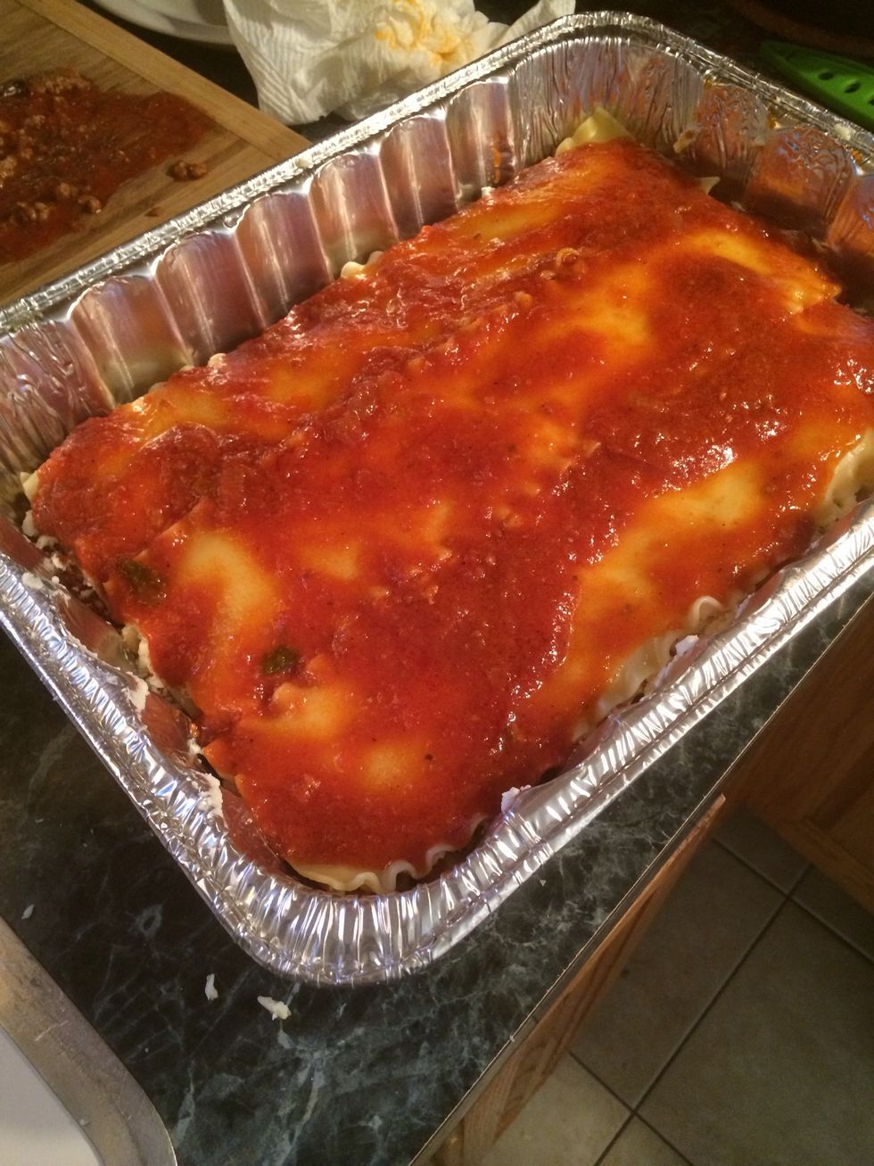 Add another layer of noodles. This is now the fourth layer spread some sauce over it