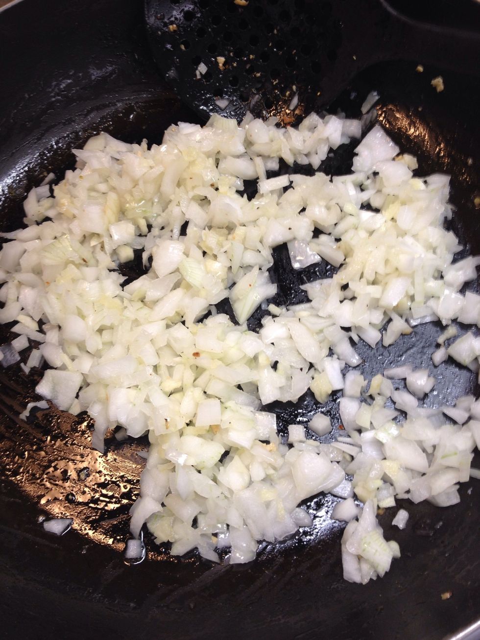 Add another tablespoon of olive oil to pan and saut\u00e9 onion and garlic. About 3 mins or until transparent. You can turn the heat down a little, so you don't burn the garlic.