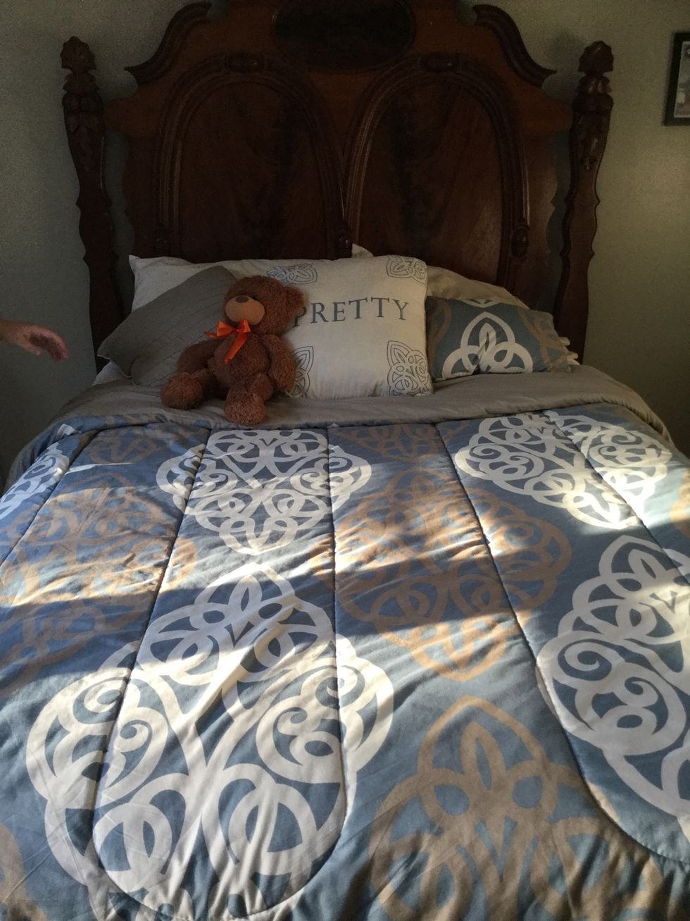 Add any personal pillow(s) or decorations to bed :)