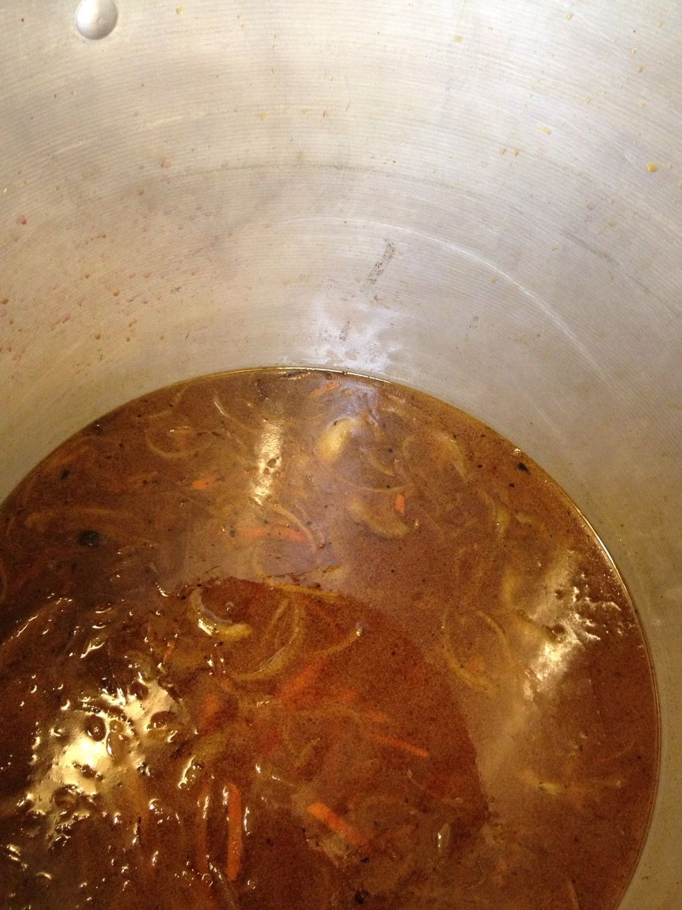 Add apple juice, red wine and stock. Then cook down.