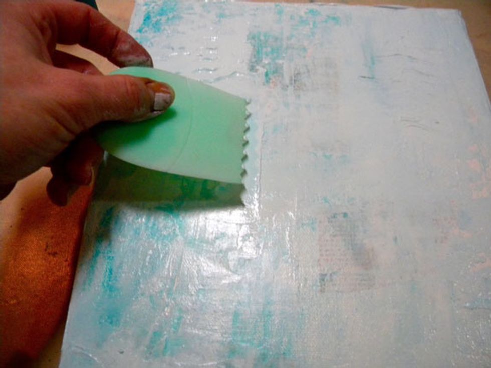 Add Art Anthology Mud on top of the Fiji to add more texture, then make marks with a catalyst tool. Make sure you can see some of the book text through all the layers. Use a baby wipe if needed.