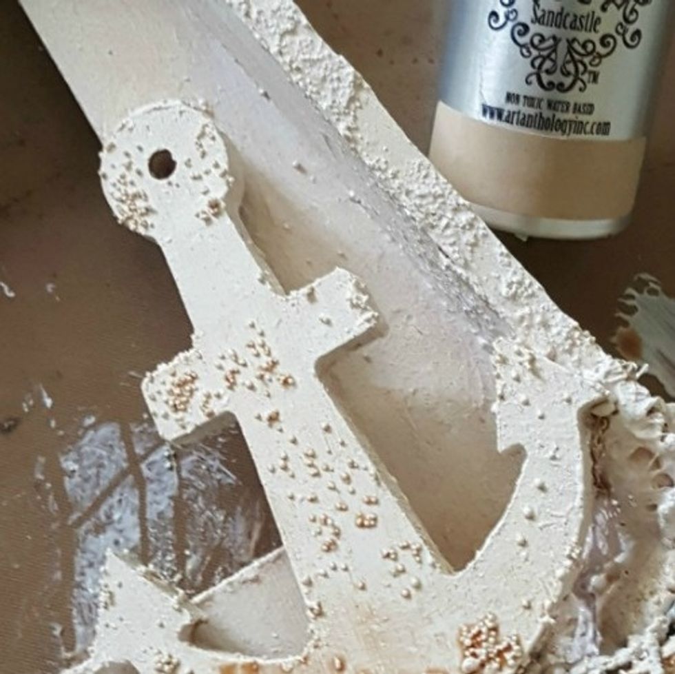 add art stones and apply gesso overtop...once dried, spray throughout with Colorations spray - Sandcastle