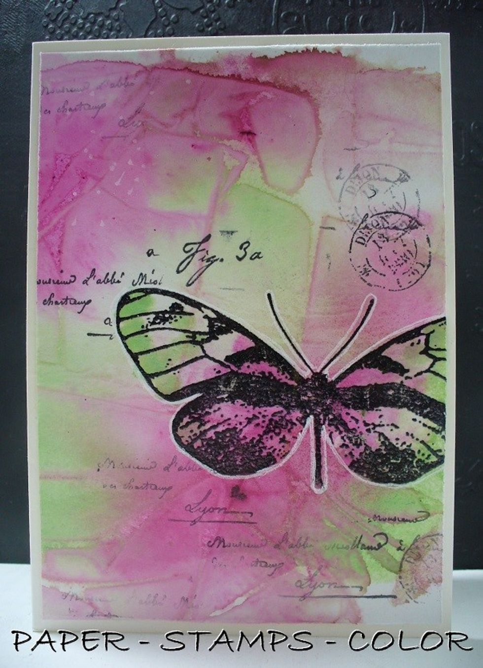 Add background stamping with the script stamp from Paper Artsy. Add a highlight around the image with an acrylic marker.