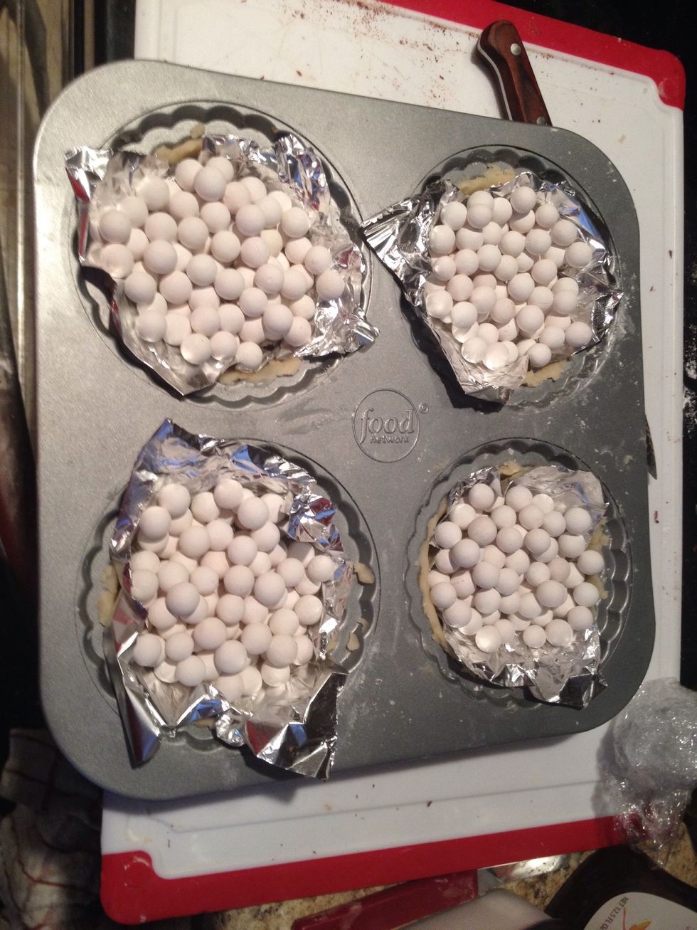 Add baking beans or pie weights on top so the pastry won't rise