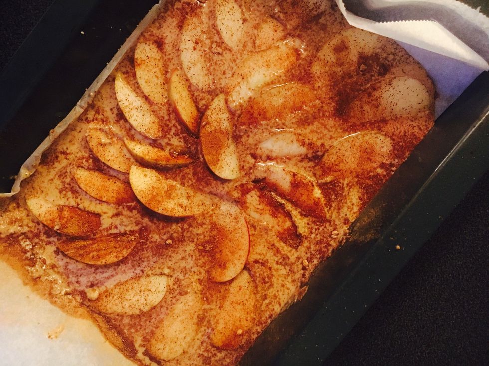 Add batter to a lined baking tray. Add sliced apples and 1 tablespoon of coconut sugar and cinnamon on top. Heat for 15-20 mins on 175 degrees celcius.