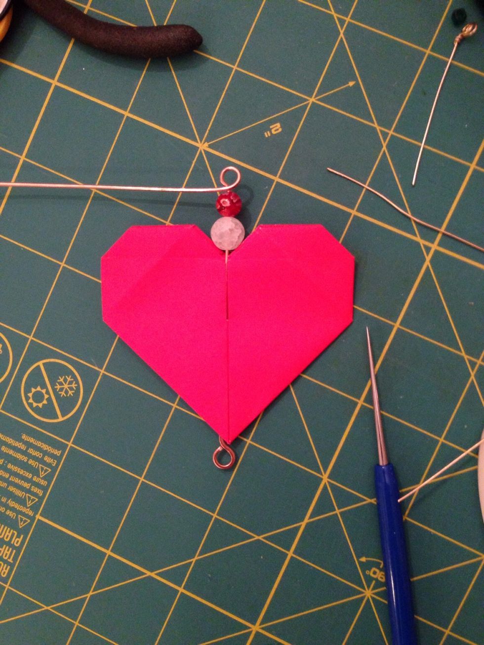 Add beads to the wire and use the pliers (round nose and chain nose) to make a wrapped loop at the top.