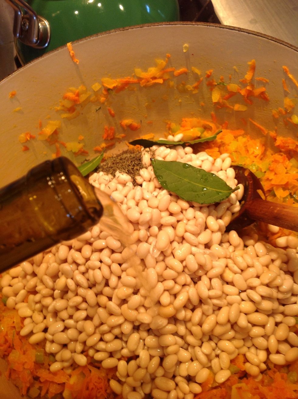 Add beans Bay leaves, thyme and white wine then start to reduce