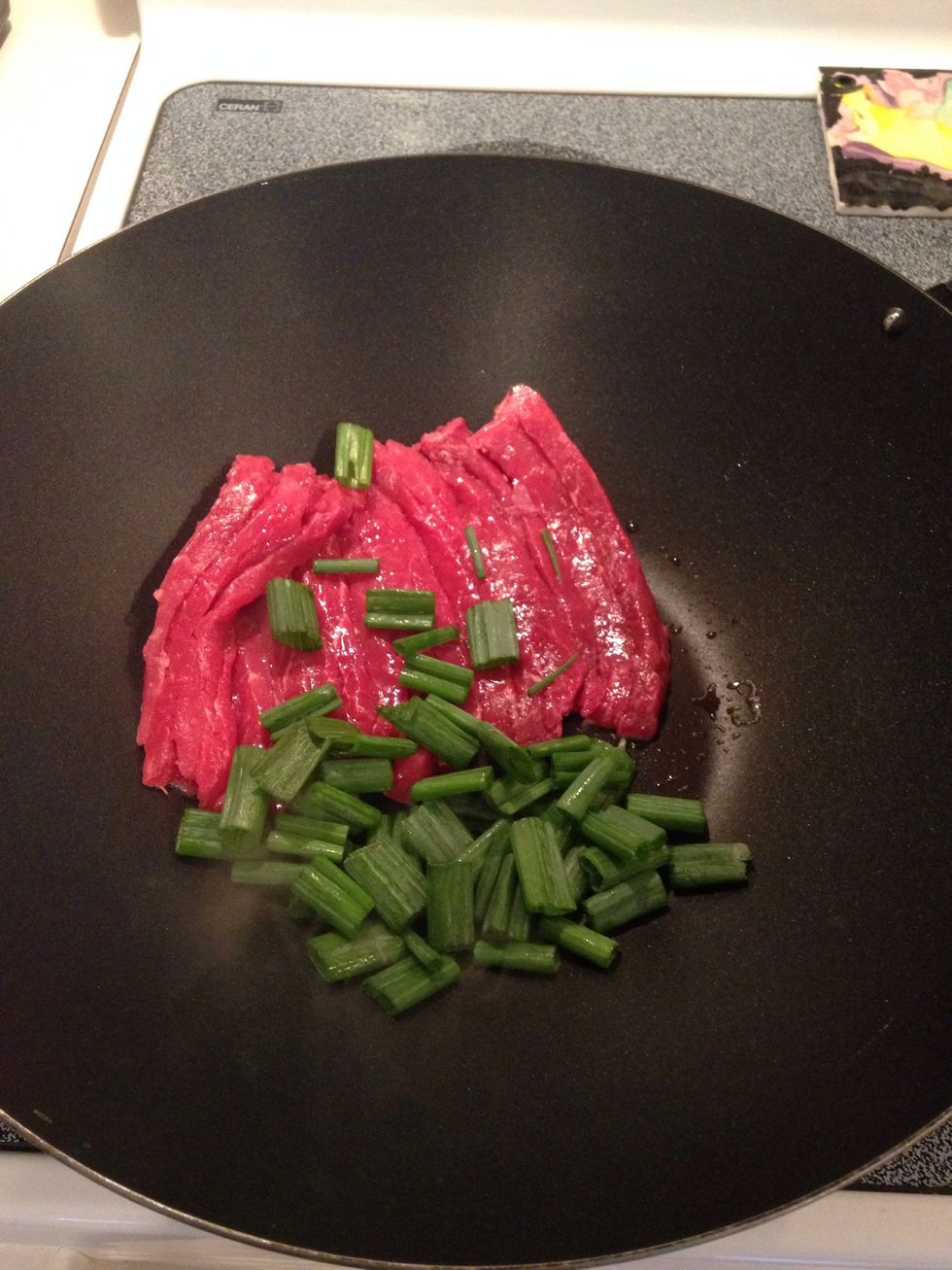 Add beef and green onions to oil. Stir fry 1 minute.