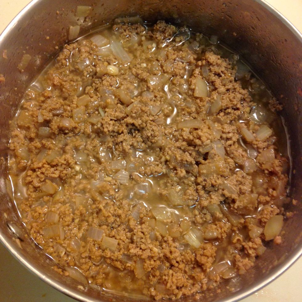 Add beef. Cook until brown with no pink remaining, then drain the mixture and return to pan.