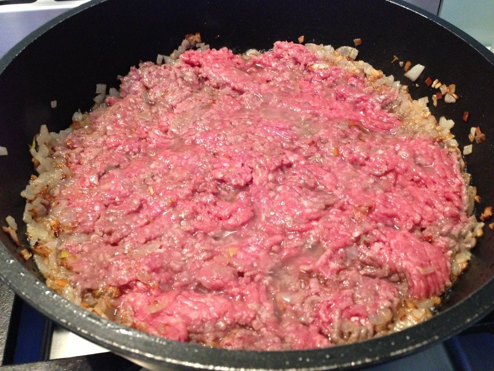add beef, Spread mince to cover bottom of pan use back of ladle to cut mince into small pieces, fry till all sides are cooked