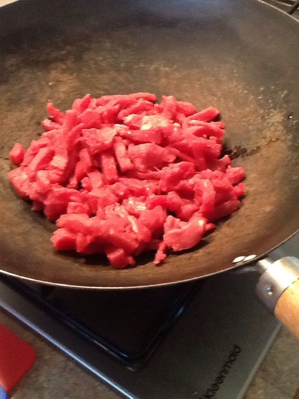 Add beef to wok and cook until brown.