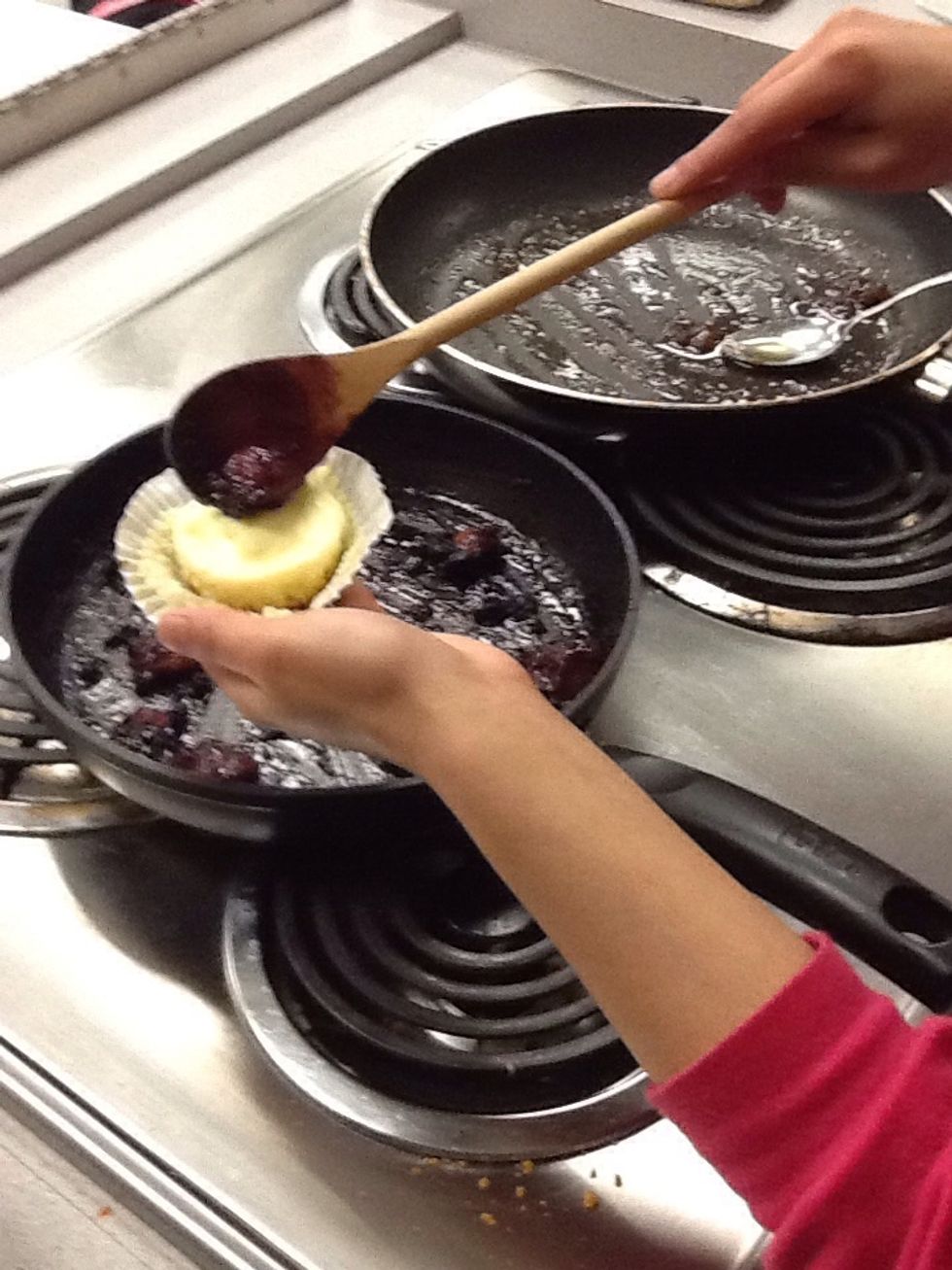 Add berries to top of cheesecake then remove cupcake liner