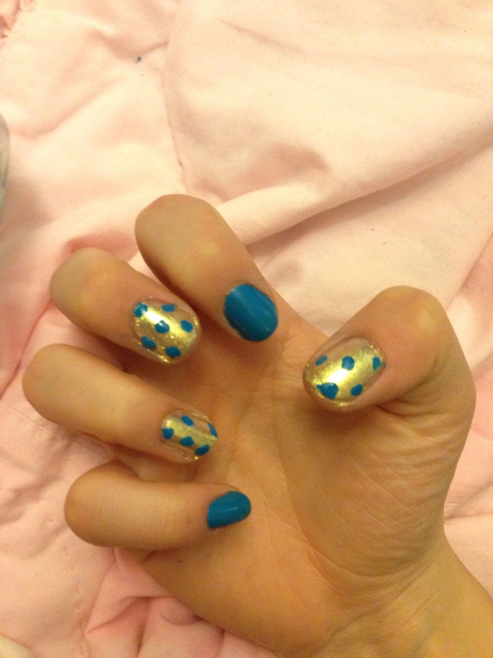 Add big blobs of blue on the gold nails