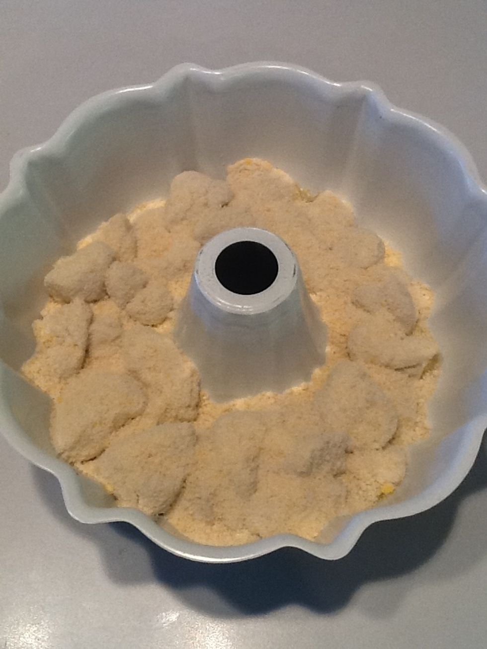 Add biscuit pieces on top of the melted butter. Sprinkle remaining Parmesan cheese over bread.