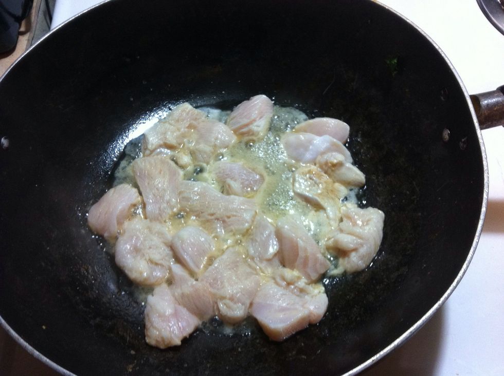 Add bit of oil, and cook the chicken.  I only rinsed the wok to keep the seasoning in the wok. Notice the orange seasoning  around the chicken. Boom!