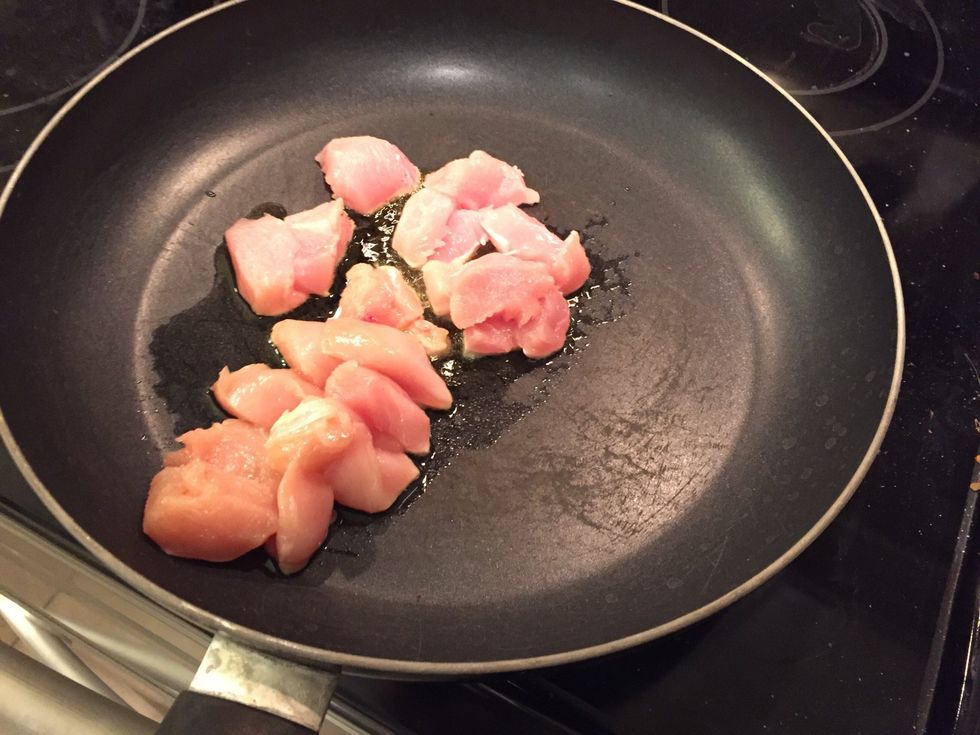Add bite-sized chicken to hot oil in pan.\ud83c\udf57