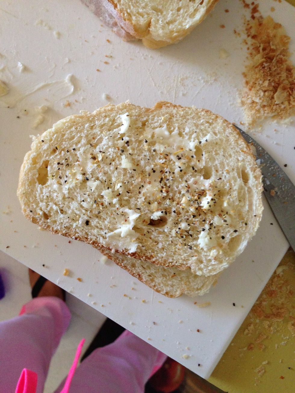 Add bits of butter. You can spread it or leave it. I usually just leave the butter but mine had soften up quite a bit so I spread it out. Add a sprinkle of lemon pepper.