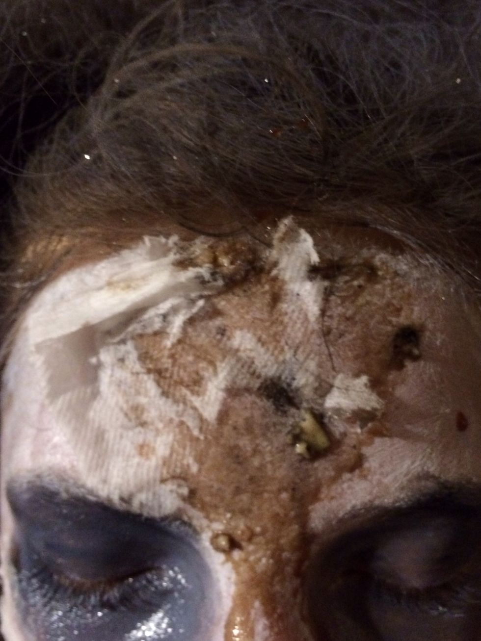 Add black around the eyes and apply more oats and syrup with Kleenex above eyes.