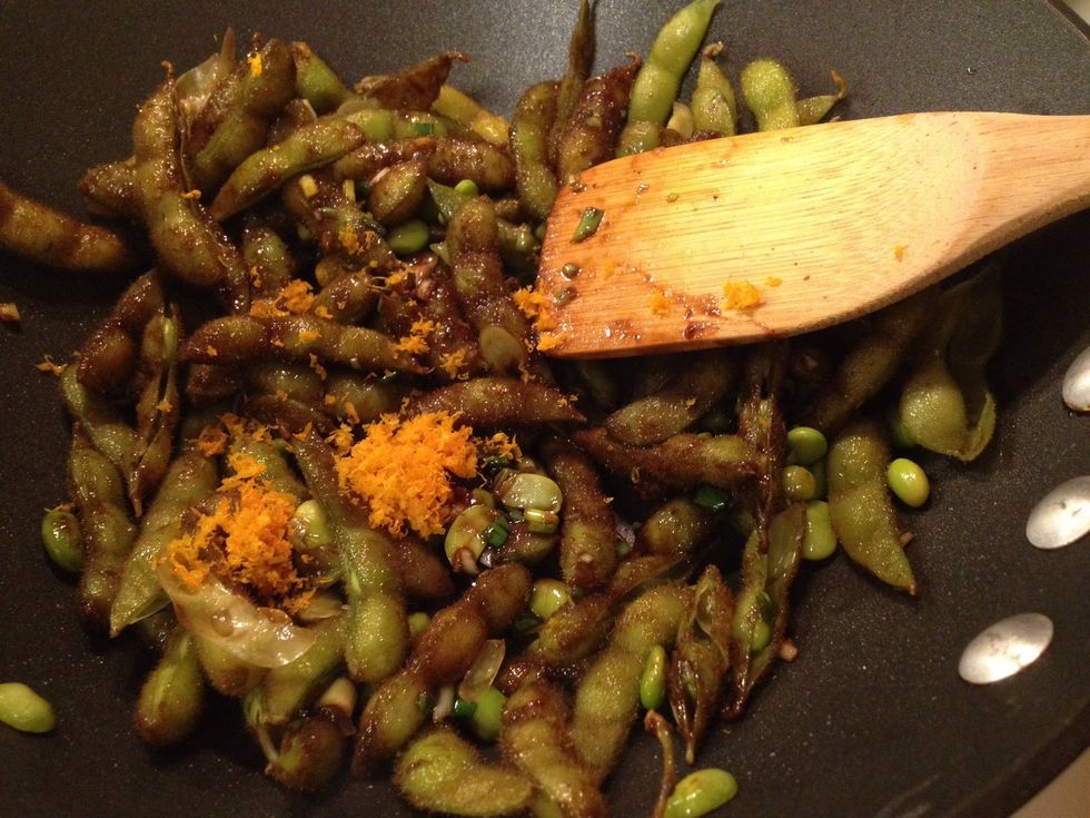 Add black bean sauce and stir one minute. Add zest and stir, then add final liquid ingredients. Cook until the liquid turns to a glaze and very little liquid is left.