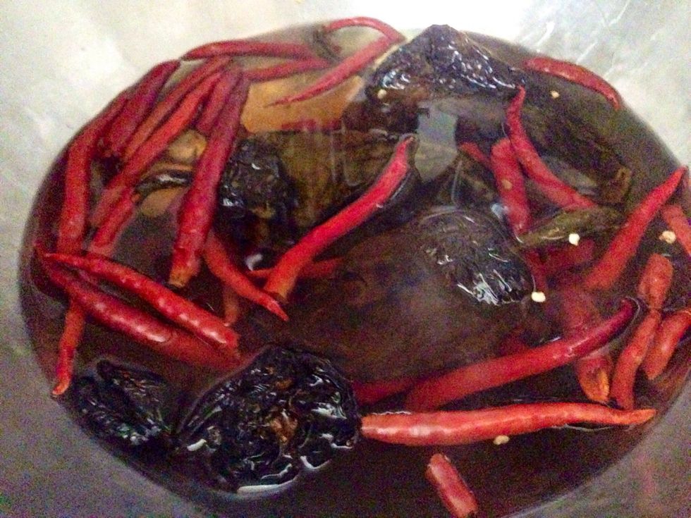 Add boiling water to your dried chili de arbol and the dried ancho chili peppers in a bowl. Let the peppers steep in the hot water for 30 minutes.