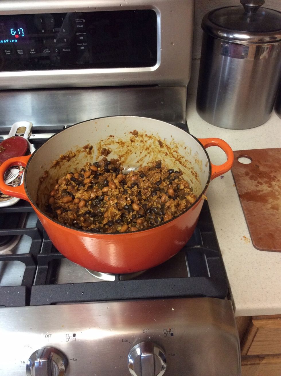 Add both cans of black and pinto beans. (Be sure to pour out the beans into a large mesh sieve and rinse under water before adding to pan).