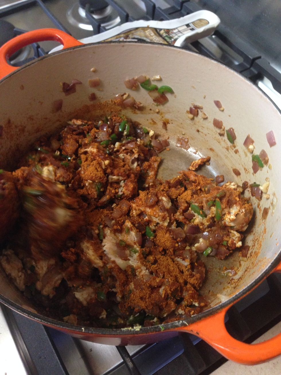 Add both packets of taco seasoning to pan. Stir to incorporate. Once the seasoning is well mixed with the chicken, cover and cook at medium heat for about 5-10 minutes.