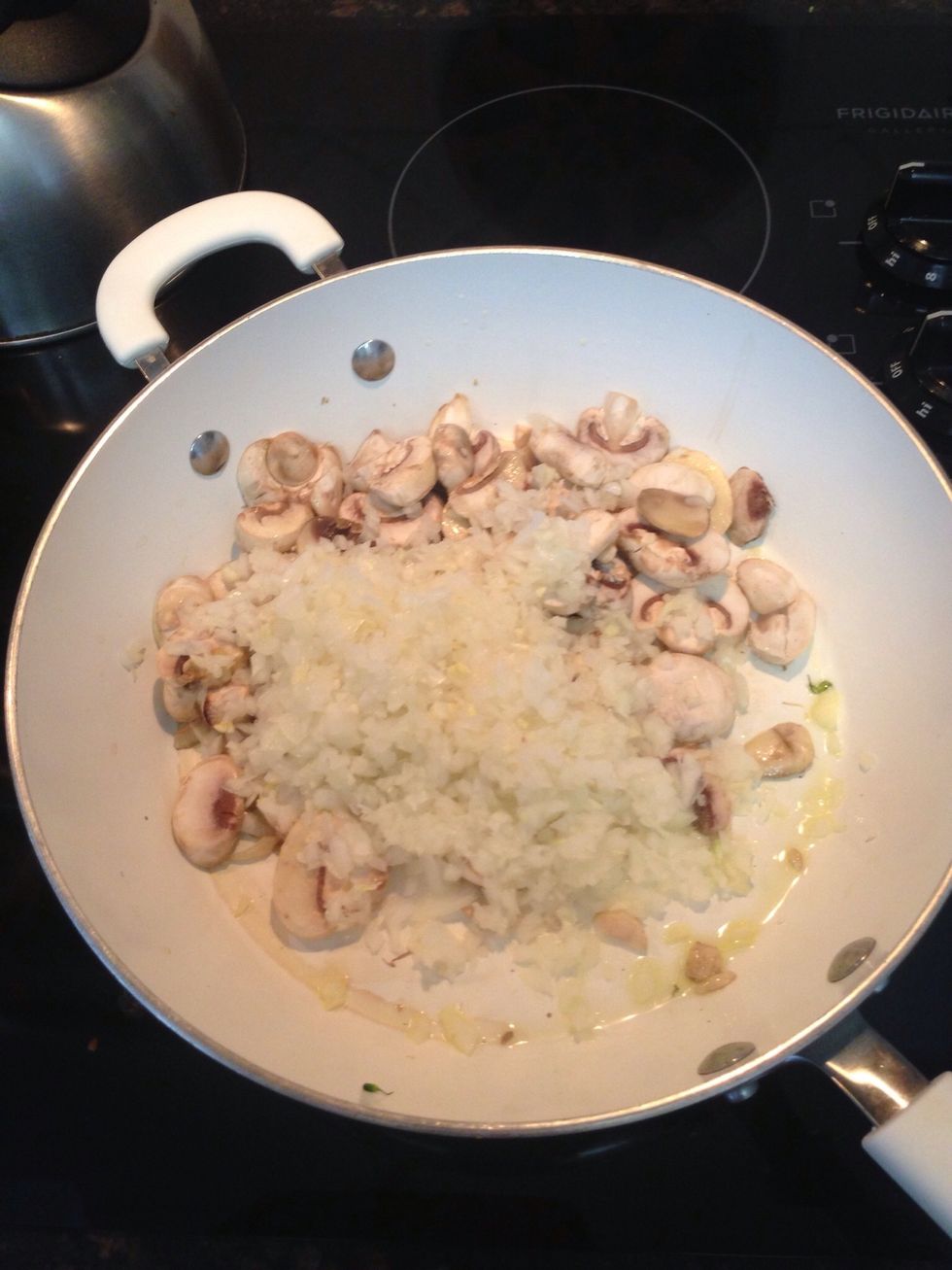 Add both the onion, garlic, and mushrooms to the hot skillet. Turn heat down to medium, avoid burning.