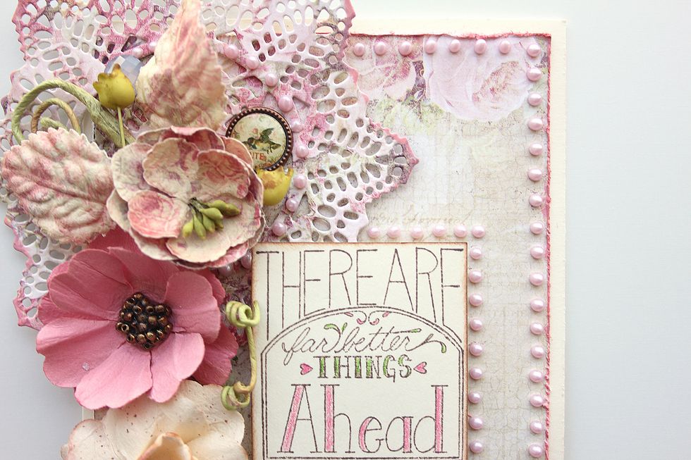 Add brad and crystals throughout the design as desired. Finish the design by adding liquid pearls to the outer edges of the card base and to frame the sentiment.