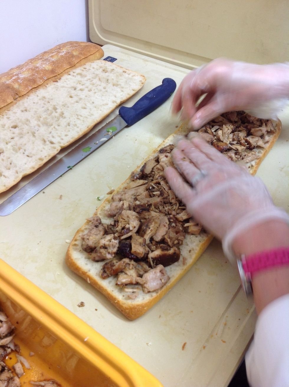 Add braised ancho chicken pieces to focaccia bread.