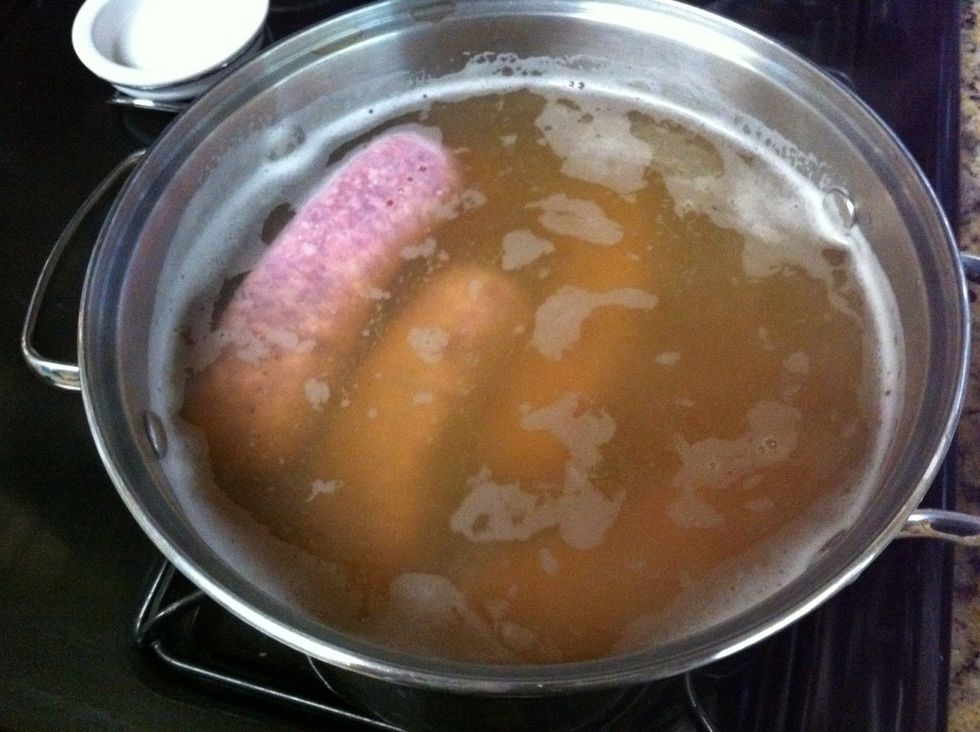 Add brats to the boiling mixture. And cook until they turn a white like color.