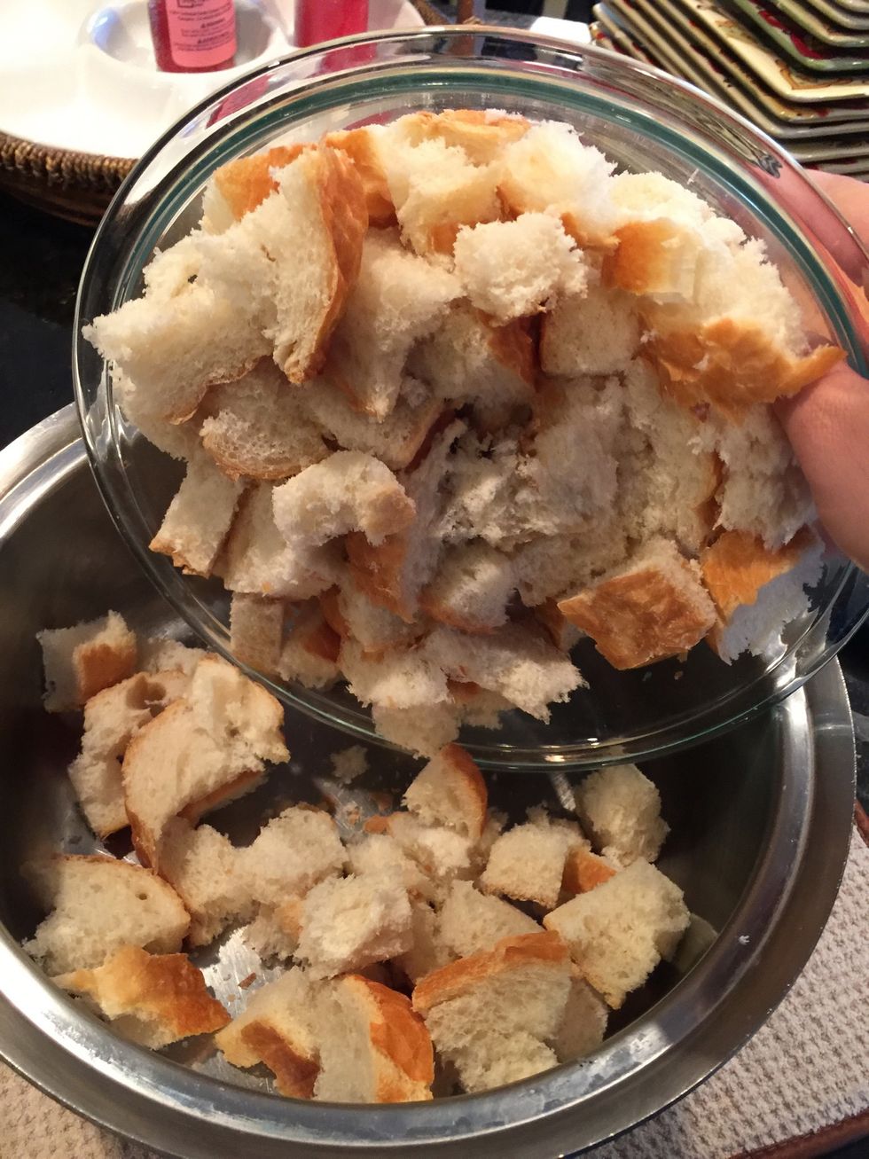 Add bread pieces to a large bowl or cooking pot.