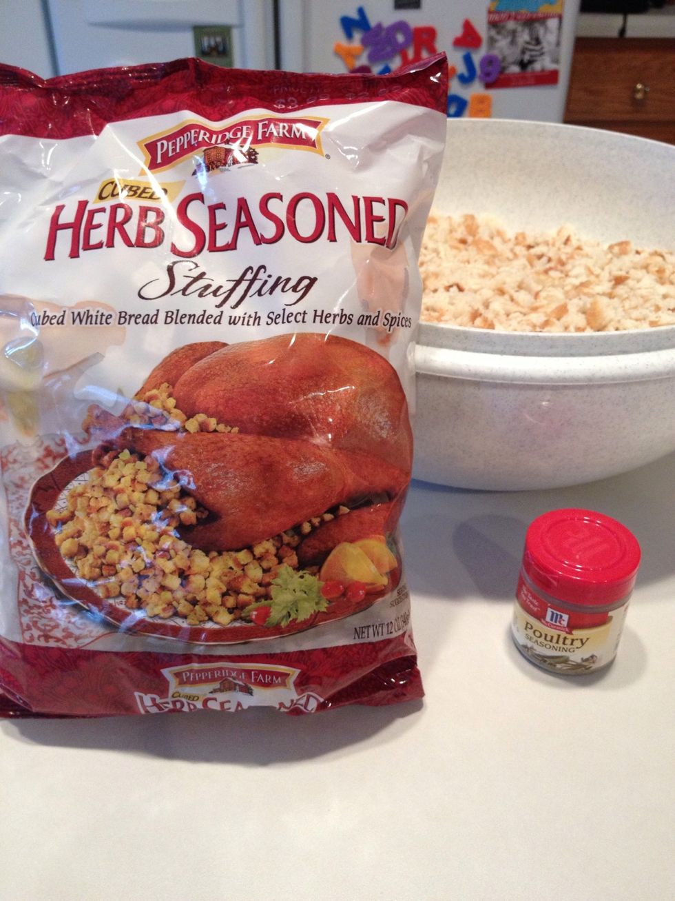 Add bread stuffing cubes and poultry seasoning to bowl of bread and stir.