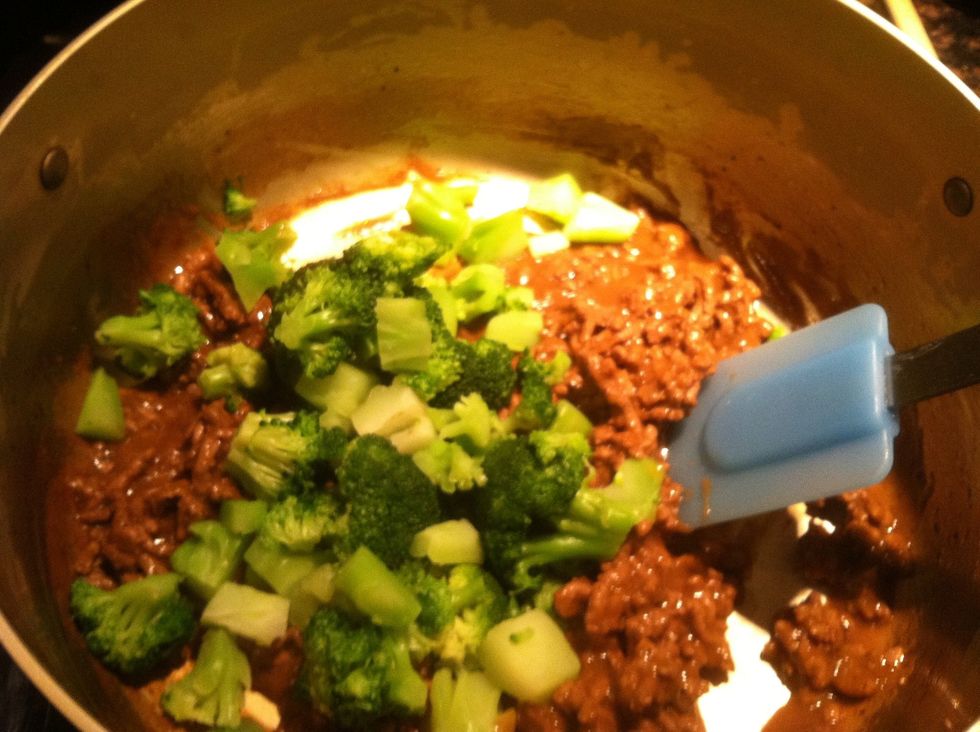 Add broccoli to meat mix, stir it in gently.