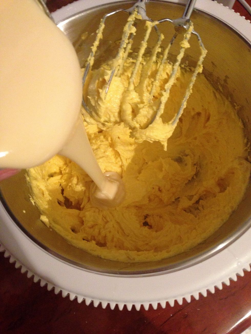 Add butter and condensed milk and continue beating