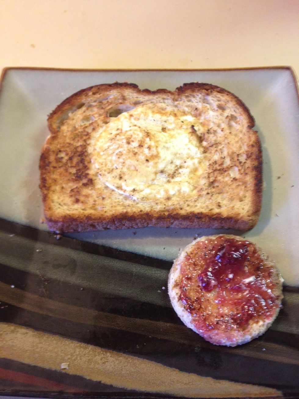 Add butter and jelly and now you have a mini toast along with your eggy-in-a-basket! Enjoy!