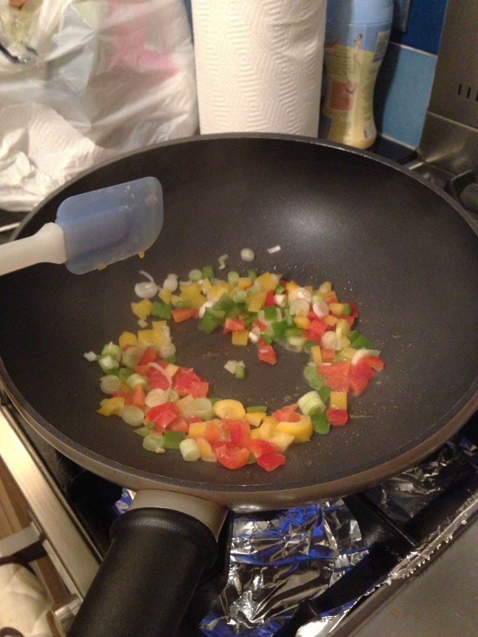 Add butter, peppers and onion to the wok...