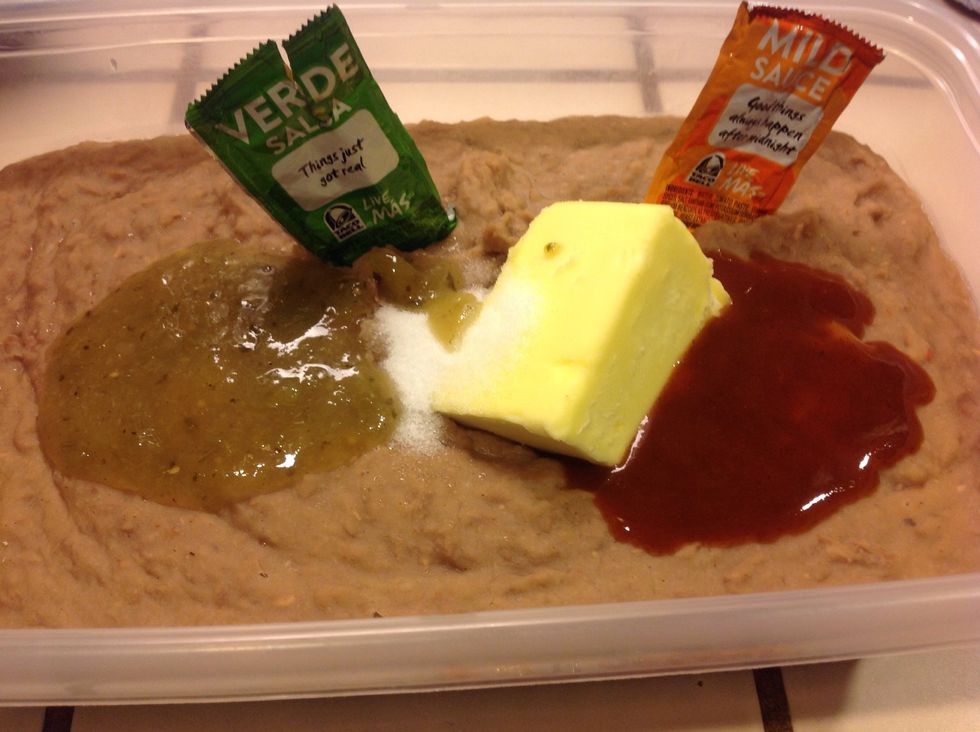 Add butter, salt, and taco sauce. (You can use any taco sauce or seasonings that you prefer.  I had some Taco Bell packets on hand.  I used five of each of these.