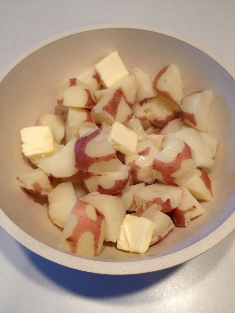 Add butter to potatoes. The heat from the potatoes will help the butter melt.