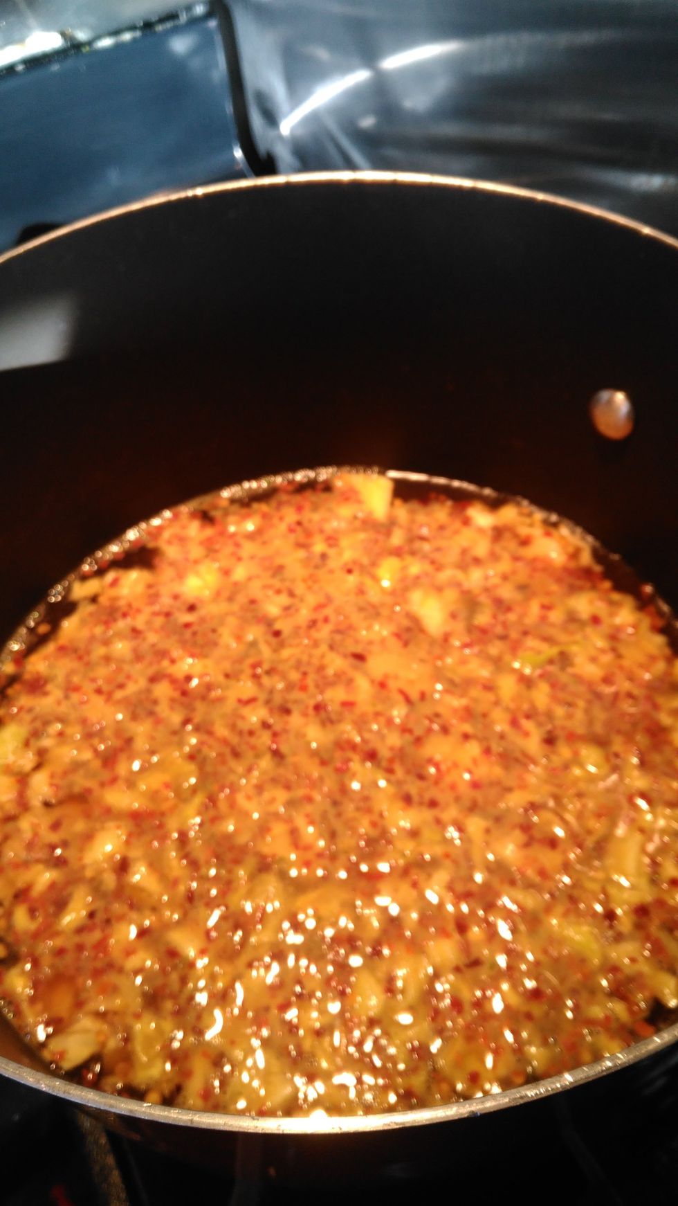 Add Cabbage in a stock pot and saute with soy sauce, garlic, sesame oil, and chili pepper flakes until the cabbage is wilted.