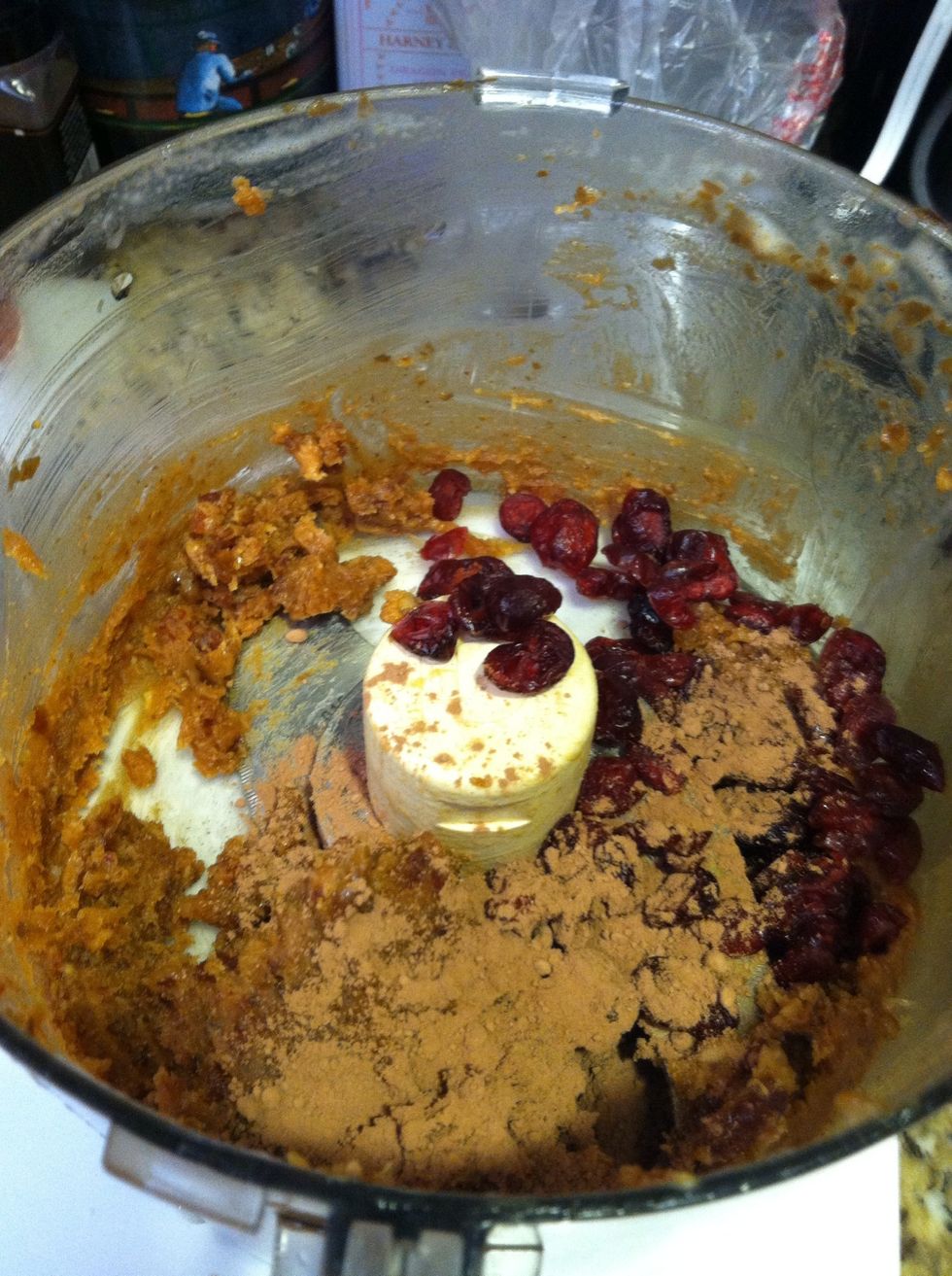 Add cacao powder and dried cranberries and continue blending until the cranberries are roughly chopped.