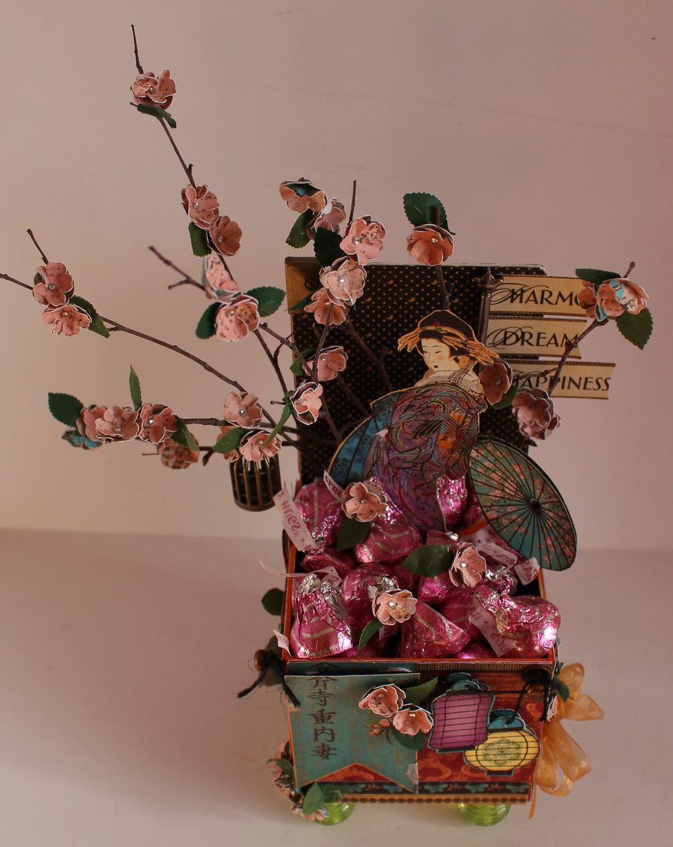 Add Candy, scatter a few blossoms on top...Adhere blossoms to twigs